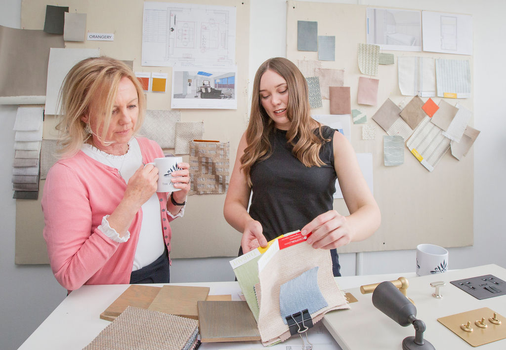 Julia and Jess from The House Ministry reviewing a design plan during a full-service interiors project in Cheltenham.