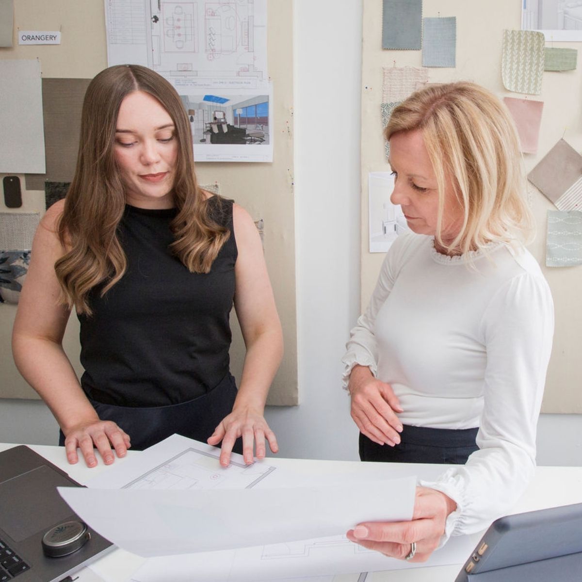 Two interior designers at The House Ministry reviewing renovation plans in the studio