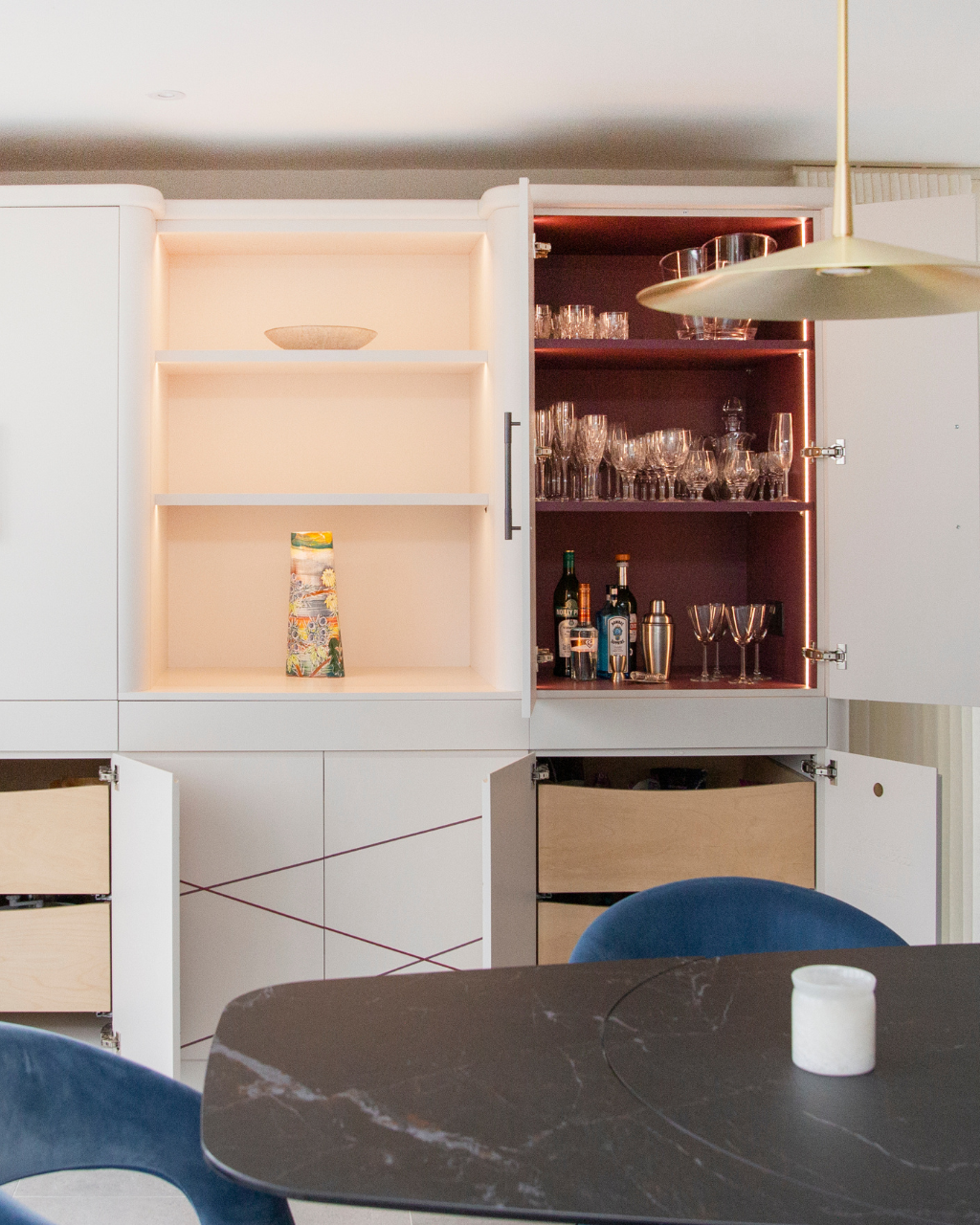 Contemporary bar cabinet with open shelving and integrated lighting in a Cotswolds home