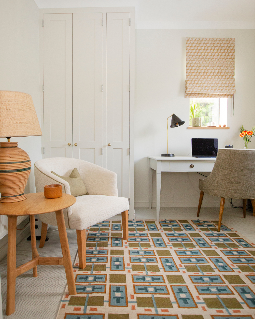 Light-filled home office with built-in storage, patterned rug and soft layered textures