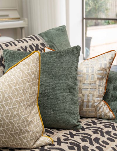 Green velvet sofa with bespoke patterned cushions