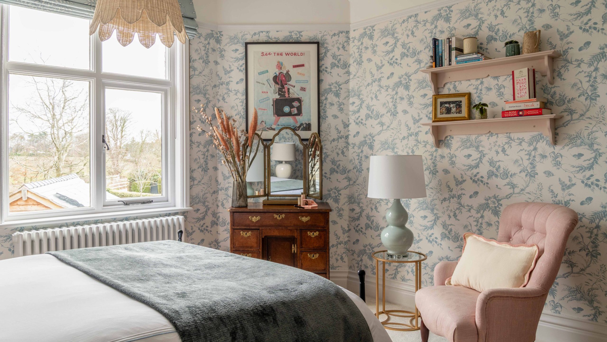 After - Finished Daughter's Bedroom with Floral Wallpaper | The House Ministry After - Completed daughter's bedroom with blue floral wallpaper, pink armchair, incorporating an existing dressing table, designed by The House Ministry