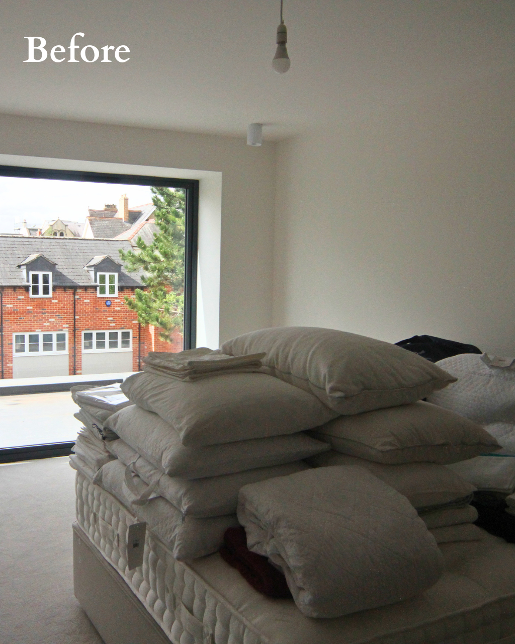Before - Guest Bedroom Before Interior Renovation | The House Ministry Before - Empty guest bedroom with bedding and pillows stacked on a bare mattress, ahead of renovation