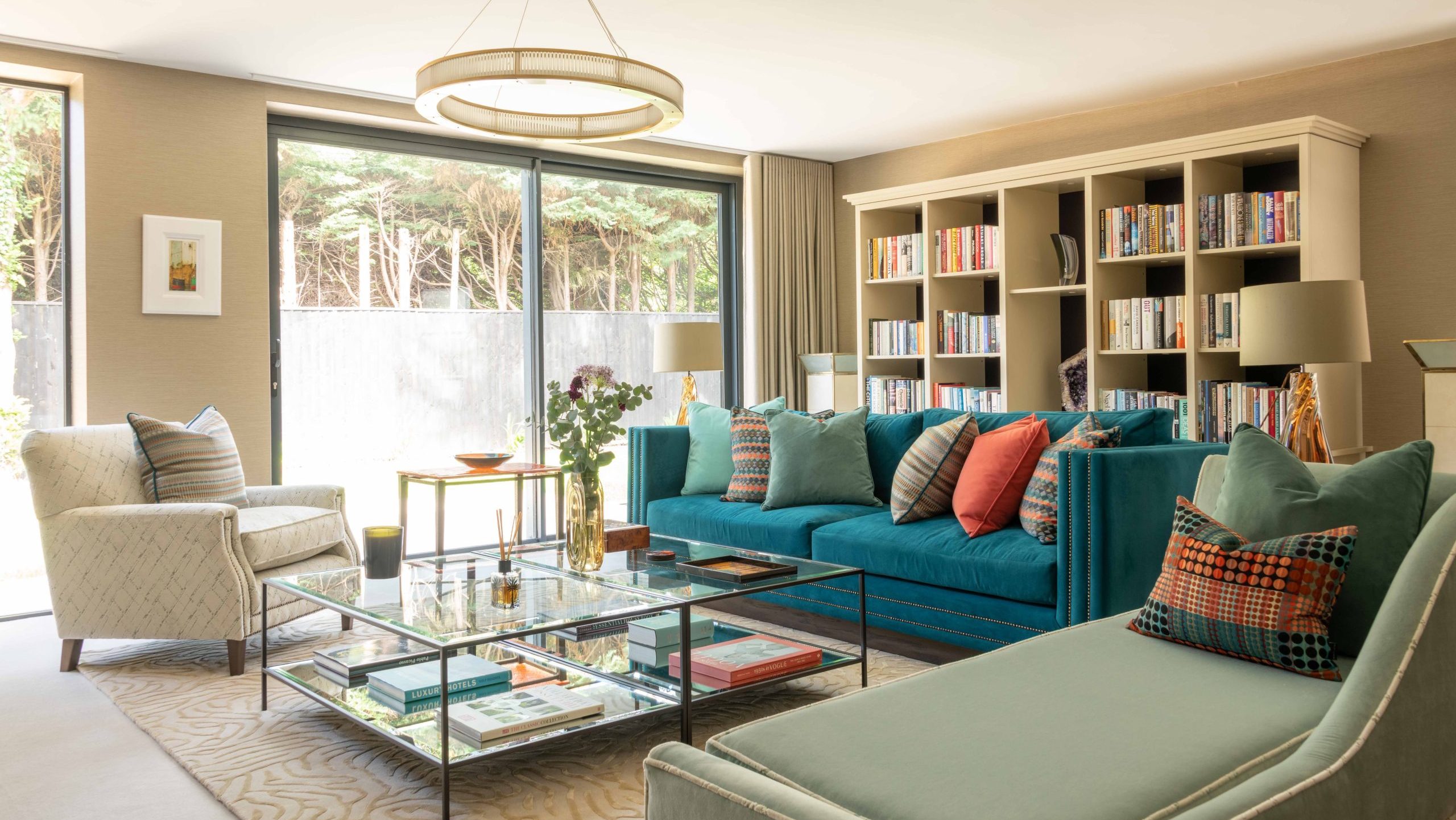 After - Living Room Interior After Renovation | The House Ministry After - Finished living room with teal velvet sofa, sage chaise longue and a bespoke bookcase designed by The House Ministry