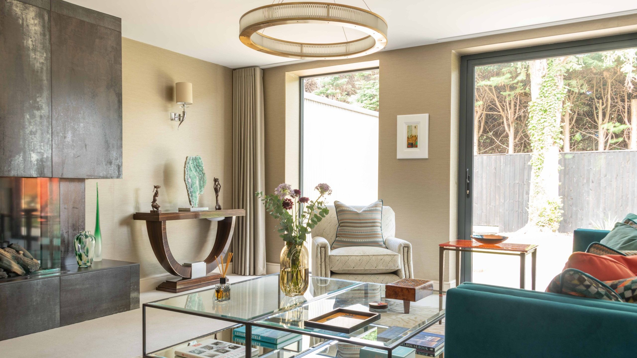 Living Room | The House Ministry Luxury new build interior design Cheltenham - sitting room with tiled fireplace, brass ring pendant, teal sofa and Macassar console table